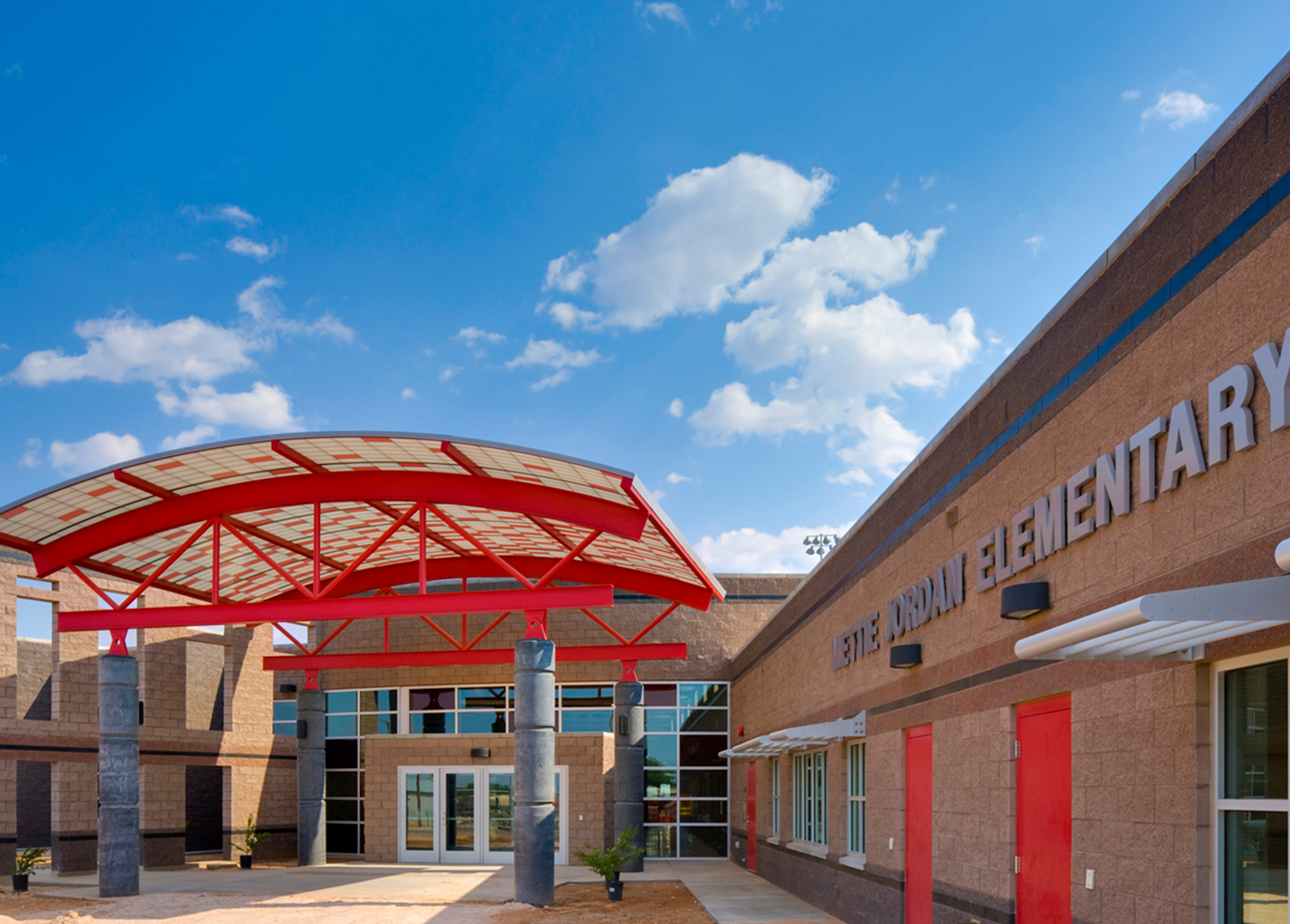Wilson & Company architects designed the entry canopies to serve as gateways to the school and community; these and other architectural elements are abstract representations of the energy business to support the community spirit. 