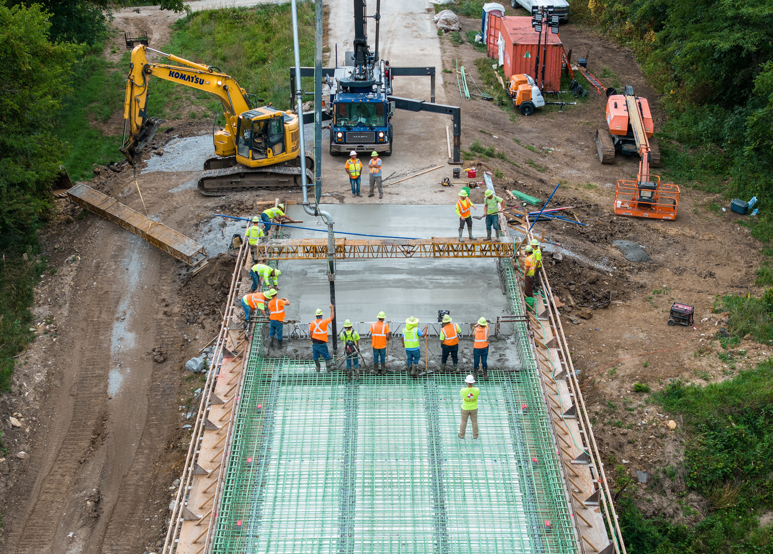 Construction crews pour a bridge deck.