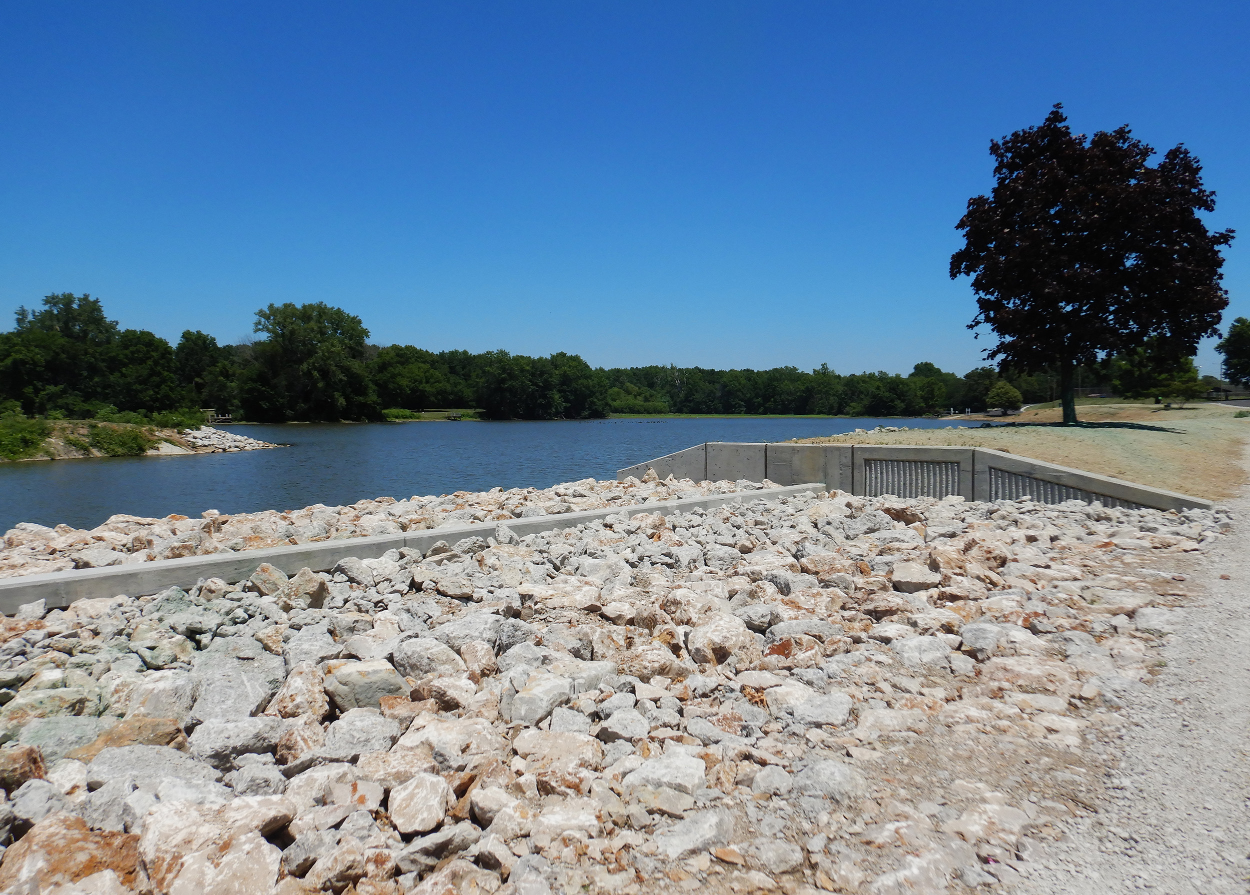 Wilson & Company designed weir spillways and side channel auxiliary spillways to mitigate risk of breach.