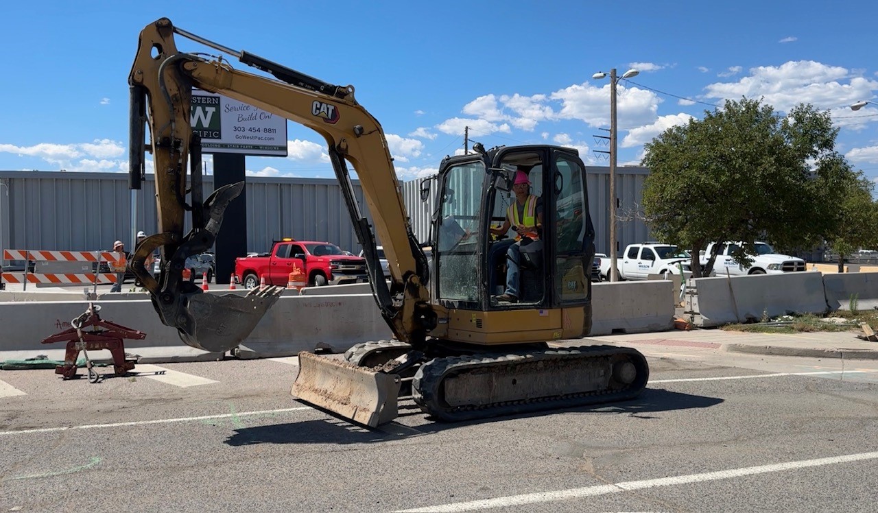 TCG participant sits in a mini excavator.