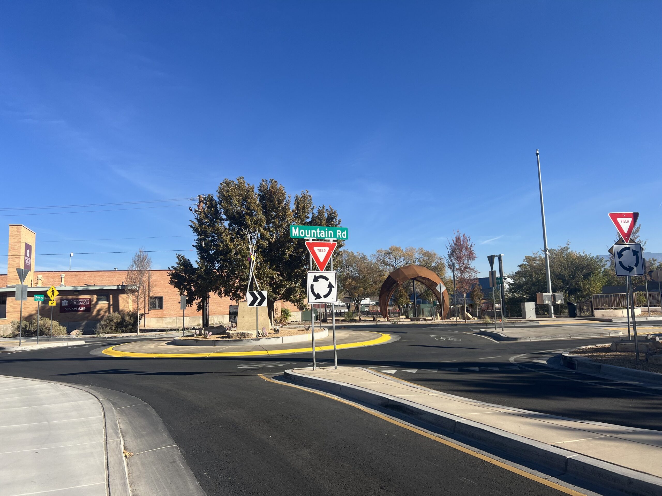 The roundabout improves visibility and accessibility, creating better navigability for all users of the trail and the surrounding community. In the background, the Mountain Road Gateway Arch at the southern entrance to the trail serves as a prominent landmark beckoning users to approach the trail.