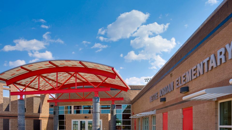 Wilson & Company architects designed the entry canopies to serve as gateways to the school and community; these and other architectural elements are abstract representations of the energy business to support the community spirit.
